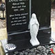 Hand carved angel headstone and kerb surround in dark grey granite Hand carved angel headstone and kerb surround in dark grey granite