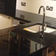Worktops in 'Steel Grey granite with splash backs in white quartz